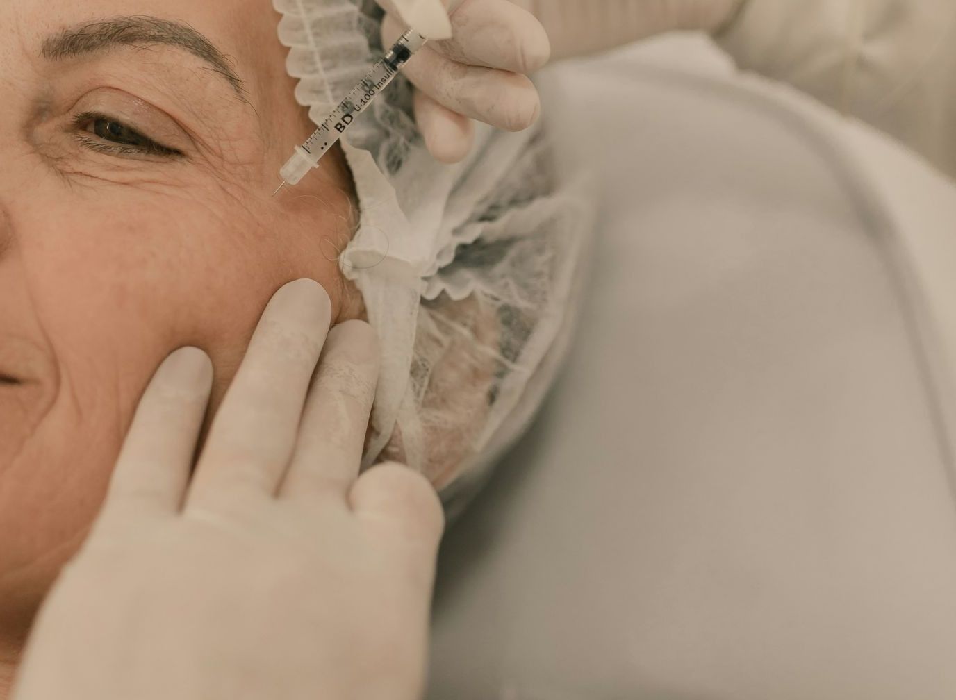 A woman getting her hair done by a hair stylist